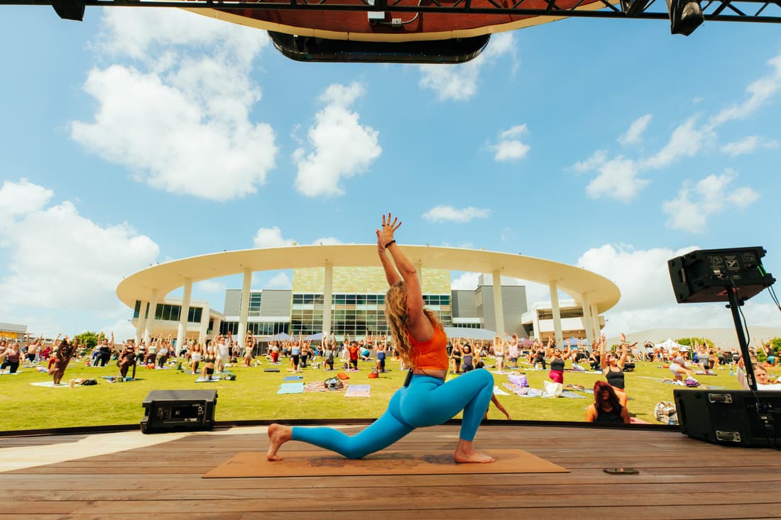 Liz teaching a large outdoor yoga class